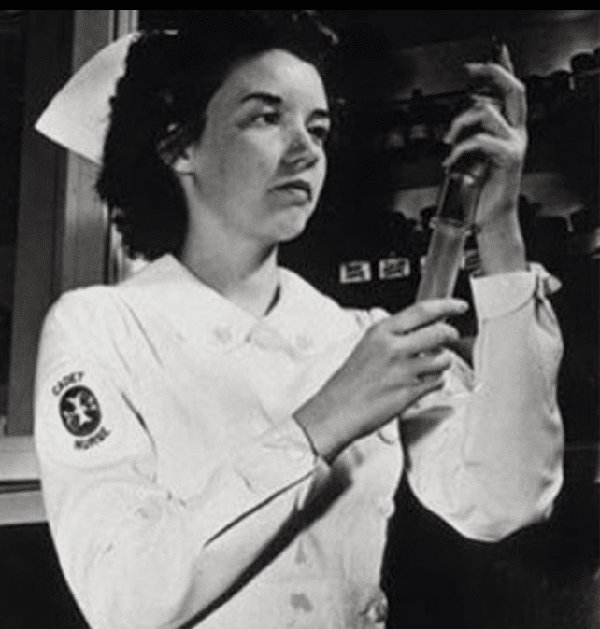 Cadet_Nurse_Corps_holding_a_glass_syringe.png